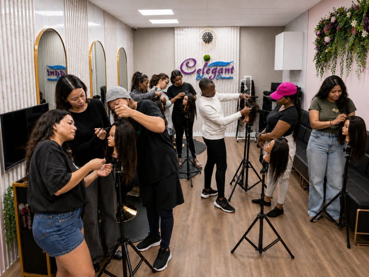 Students practising braiding on mannequin heads at tripod stands in the Celegant classroom