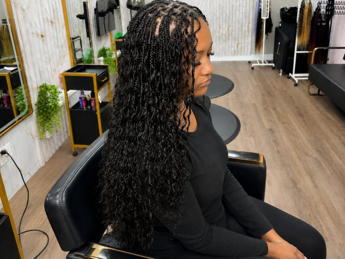 Long boho knotless braids with curly ends, finished at Celegant Hair Edmonton