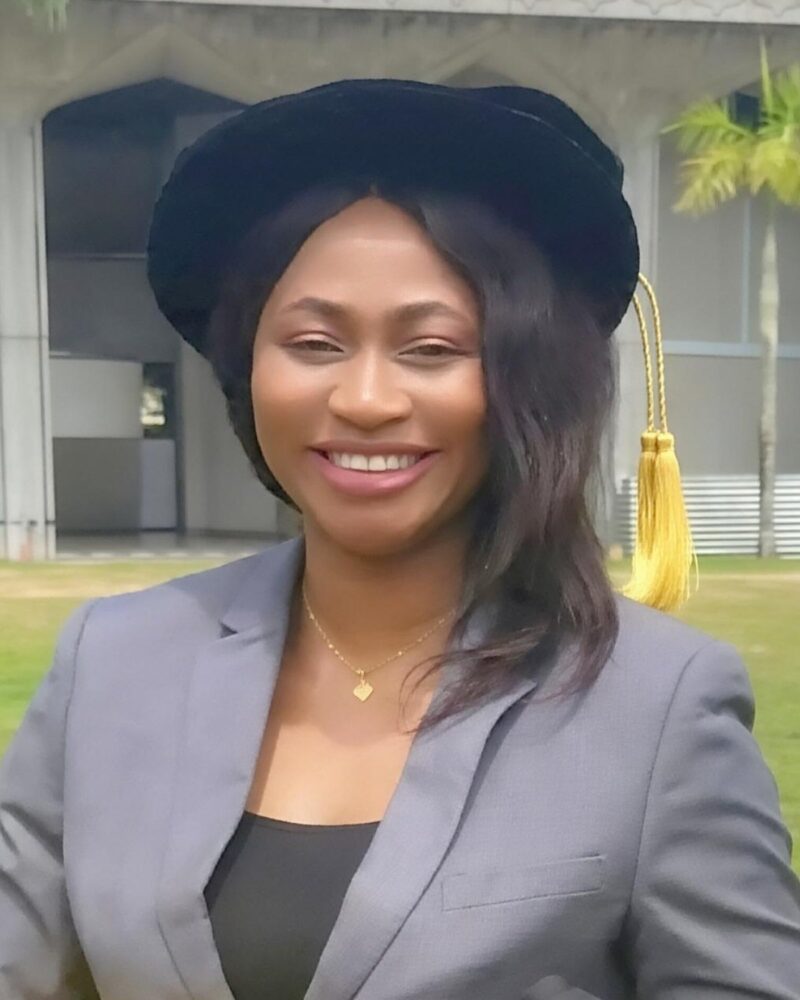 Dr. Tina, lead instructor at Celegant Braiding Academy, wearing her doctoral cap at graduation